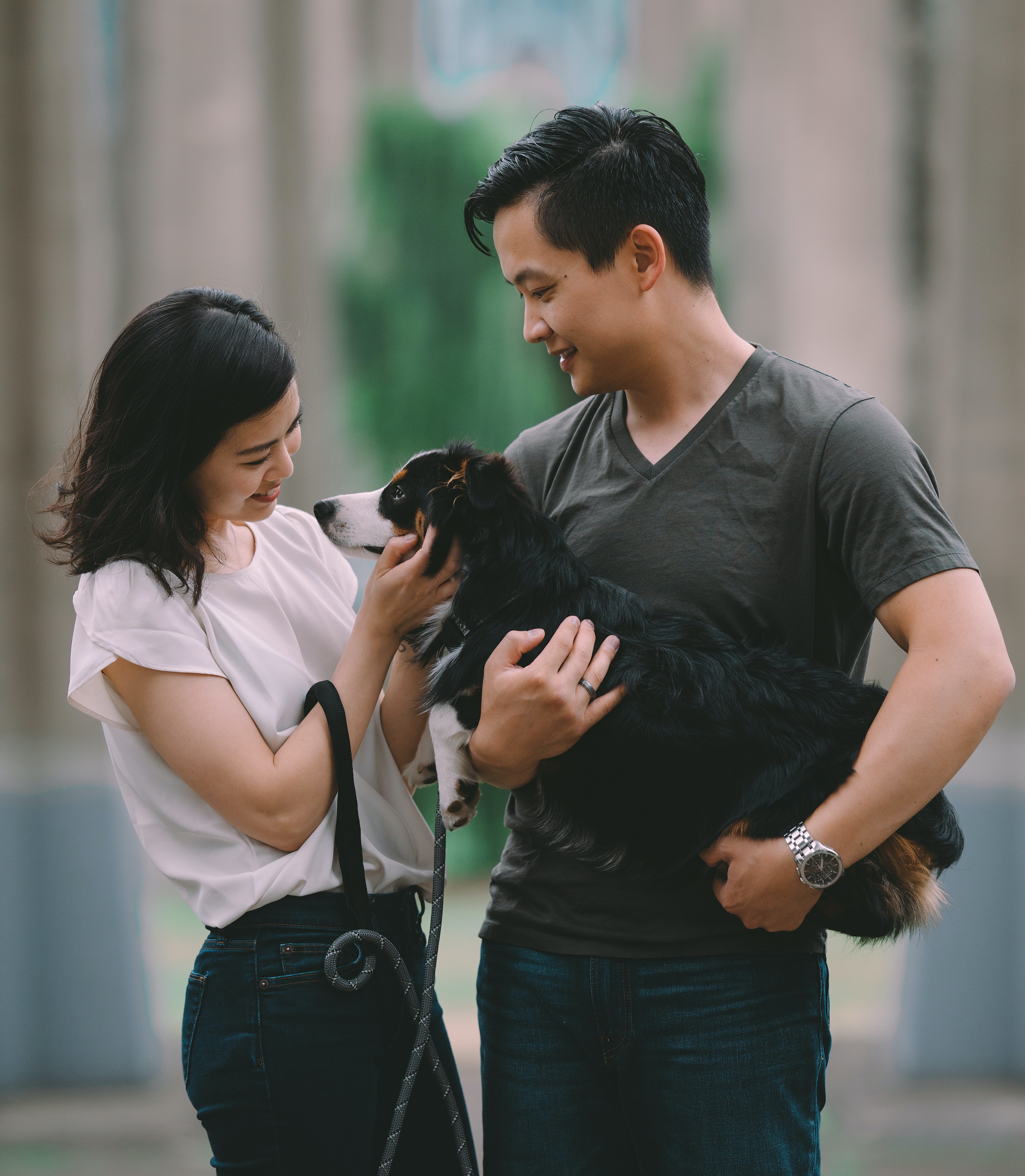 man and woman petting dog